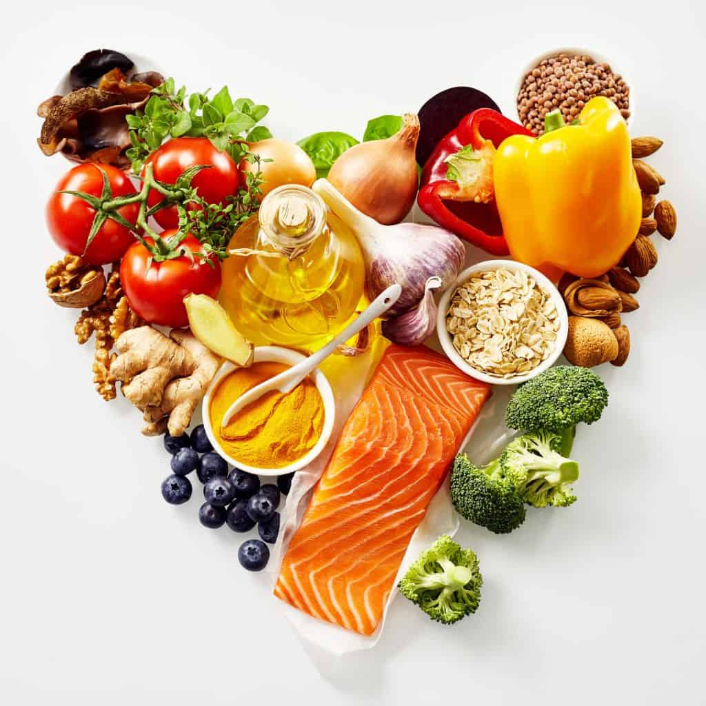 a selection of food arranged in a heart shape