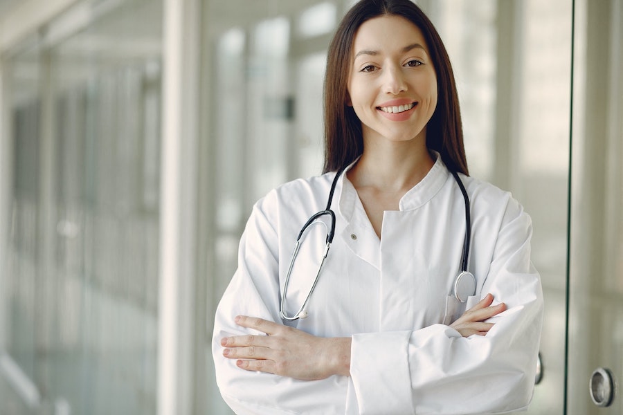 doctor standing in hospital setting smiling at patient - Brilinta dose guidance
