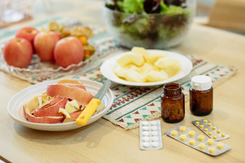 When to take Dexilant - food alongside pills on a table combining Dexilant with mealtimes