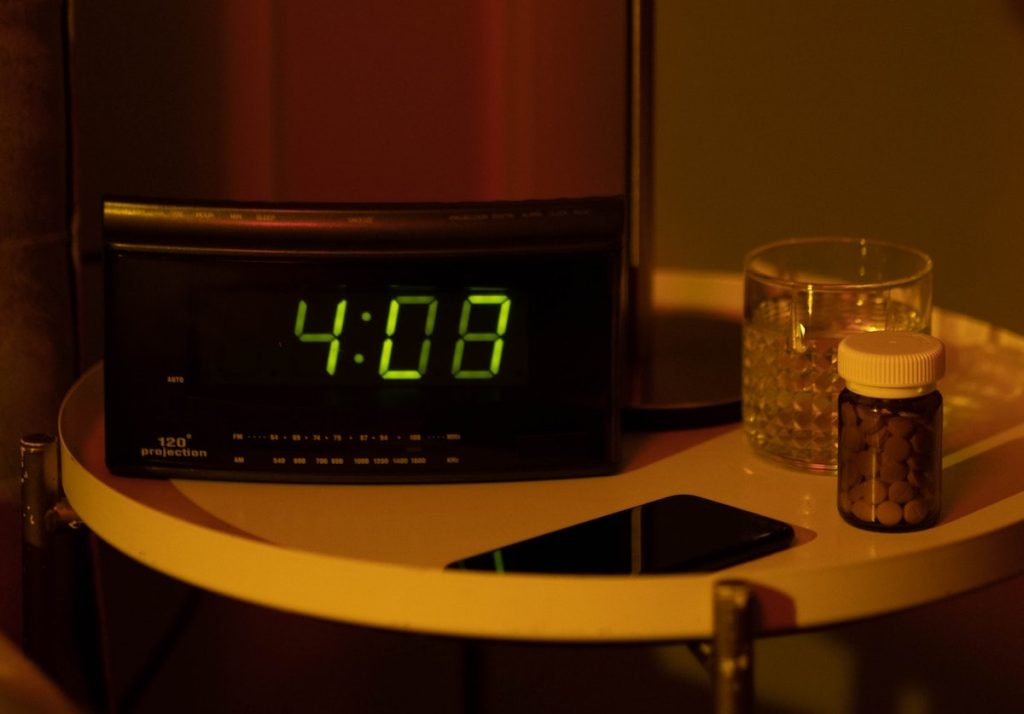 when to take dexilant - a nightstand with clock and pill bottle is not uncommon for night shift workers