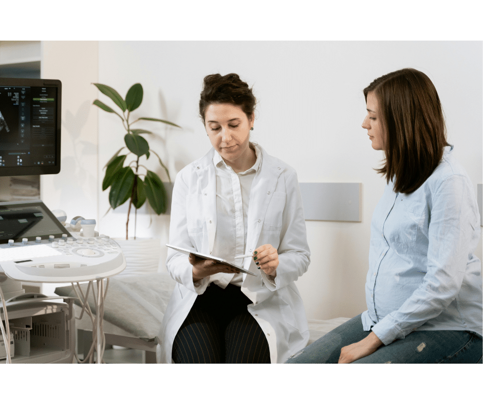 Pregnant woman talks with her doctor. Woman can be at higher risk of blood clots during pregnancy, especially if they have factor V Leiden while pregnant.