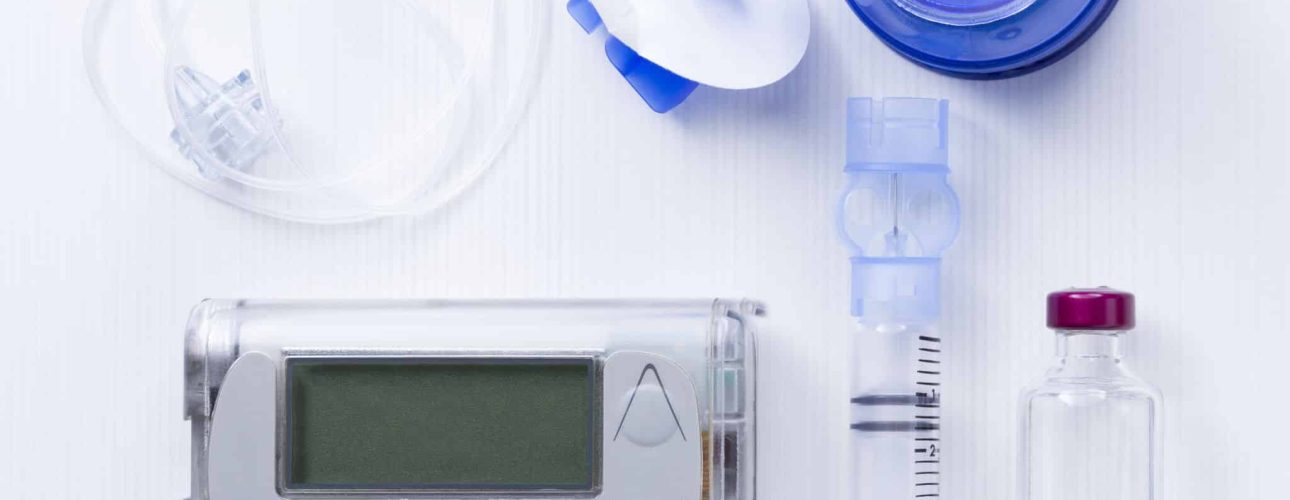 top view of an insulin pump set background consisting of: an insulin pump, insertion system of the infusion set, a reservoir of an insulin pump, insulin vial and a infusion set on a white background