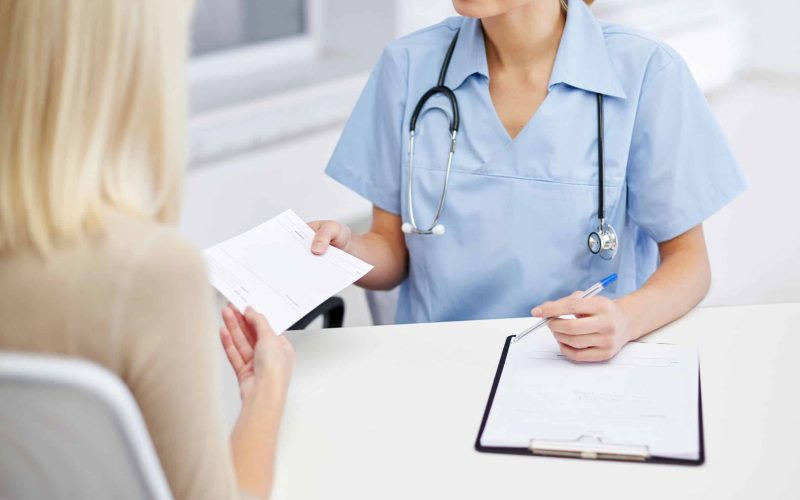 close up of doctor and woman meeting at hospital