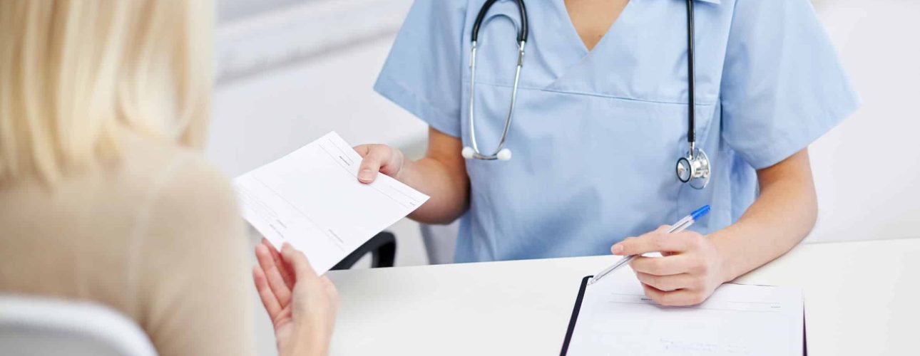 close up of doctor and woman meeting at hospital