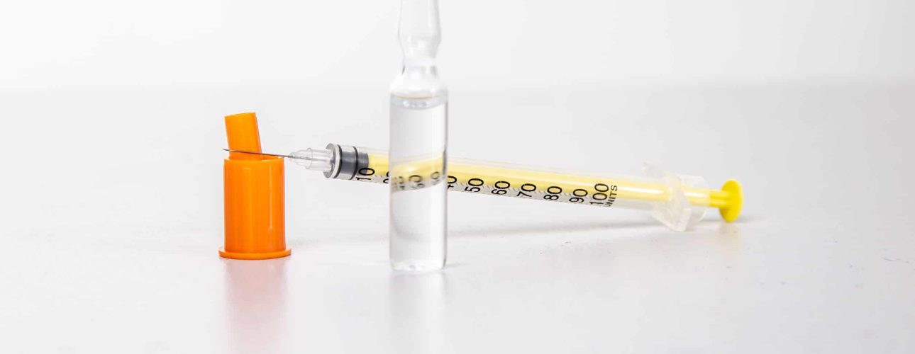 Insulin syringe with vial on a light table