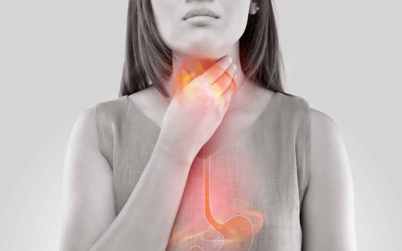 Woman Suffering From Acid Reflux Or Heartburn-Isolated On White Background