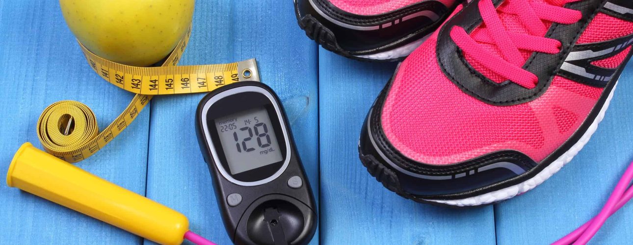 Glucose meter with result of sugar level, sport shoes, apple and accessories for fitness or sport, diabetes, healthy and active lifestyles