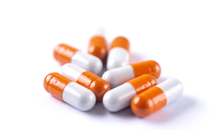 Drug prescription for treatment medication. Pharmaceutical medicament,  Pharmacy theme, Heap of orange white medicament