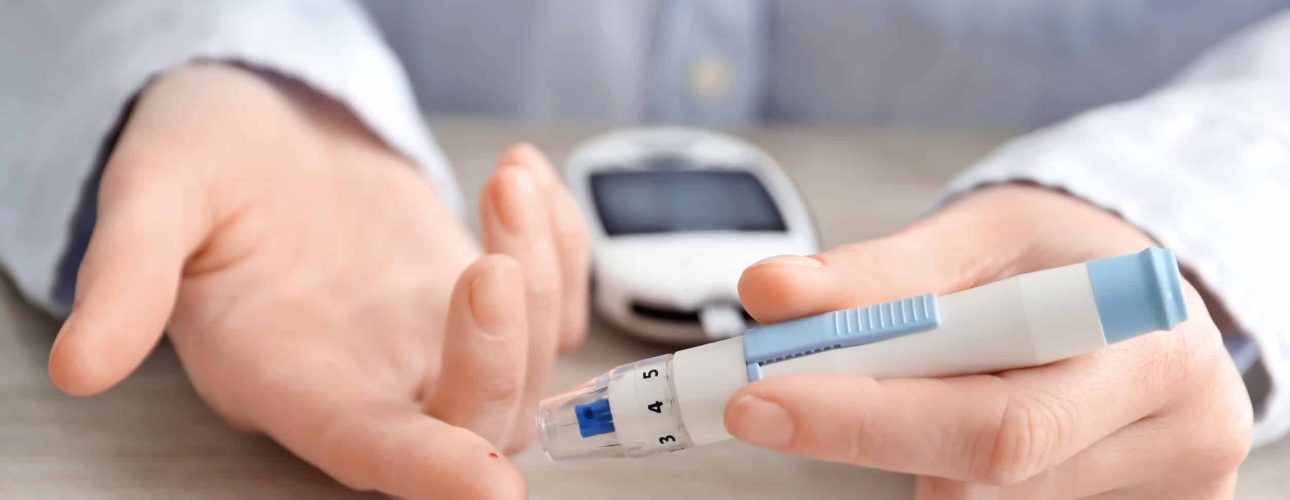 Woman using lancet pen, closeup. Diabetes monitoring