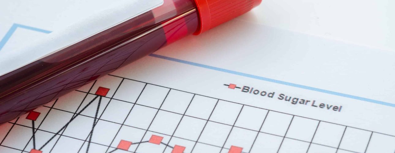 Sample blood for screening diabetic test in blood tube on blood sugar control chart.