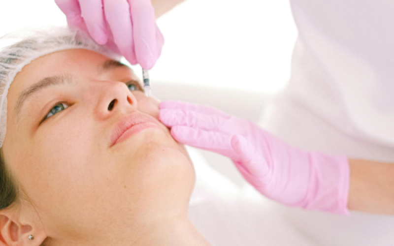 woman receives botox injection for chronic migraine