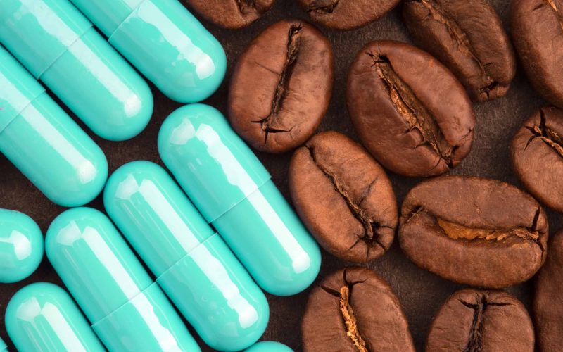 coffee beans and pills, closeup, top view