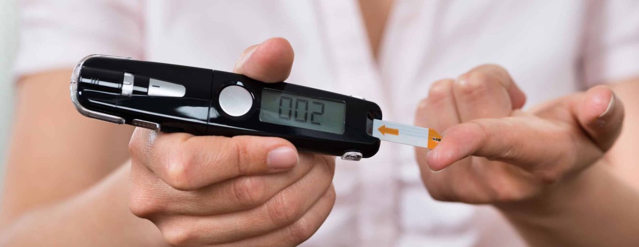 Close-up Of Woman Hands Testing High Blood Sugar With Glucometer