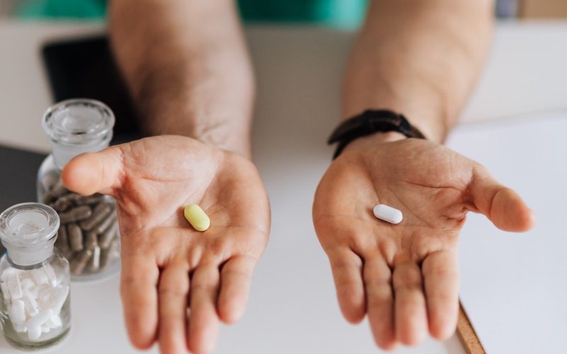 healthcare professional assessing a choice of tablets for consideration