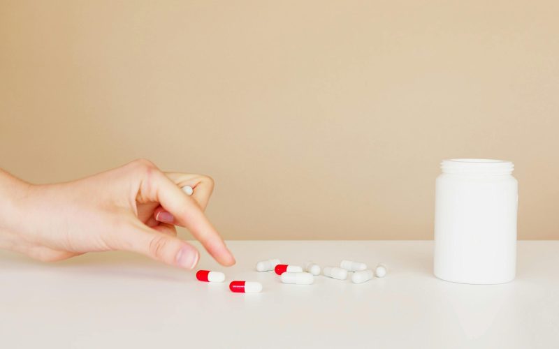 hand reaches for pills